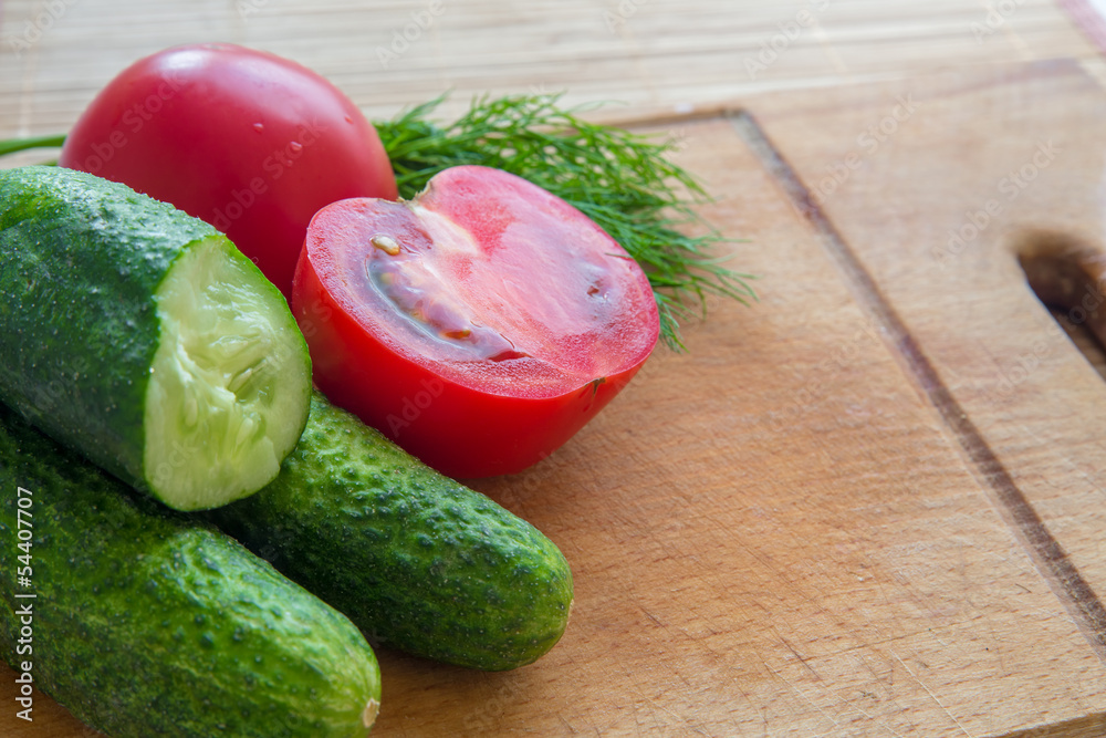 fresh cucumber and tomatoes on the board fresh cucumber and tomatoes on the board