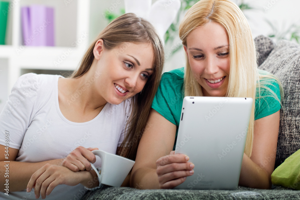 two happy young women with digital tablet two happy young women with digital tablet