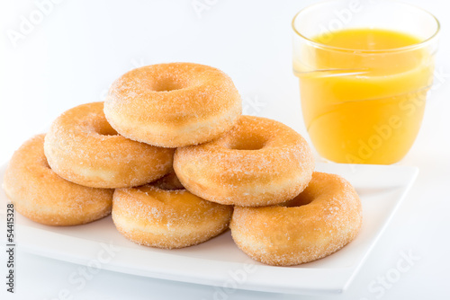 sugary donut and orange juice isolated on a white background