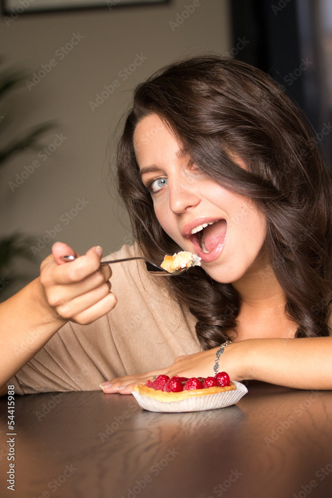 Young Woman Eating the blackberry Cake Young Woman Eating the blackberry Cake
