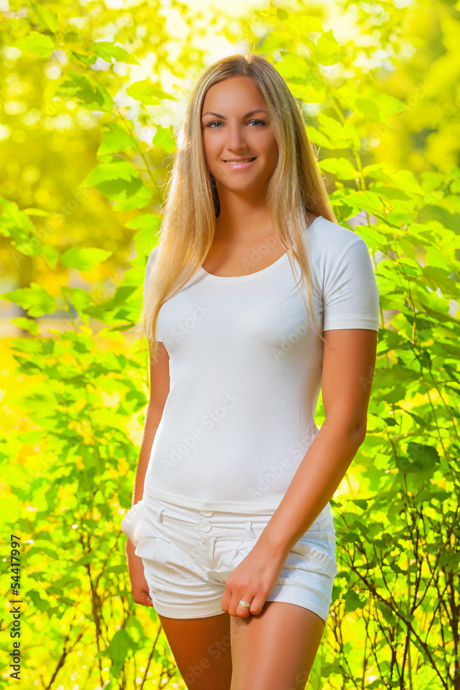 a beautiful blonde in a summer forest