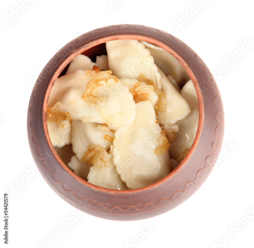 Tasty dumplings with fried onion in brown pot, isolated on