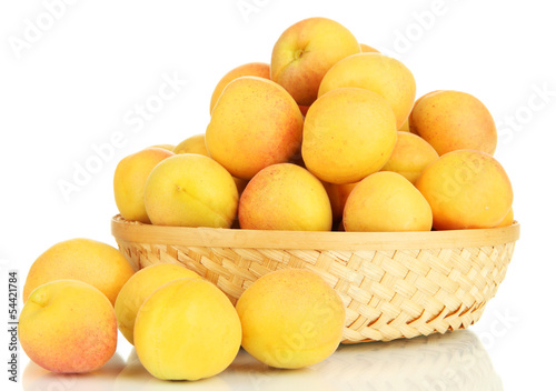 Fresh natural apricot in wicker basket isolated on white