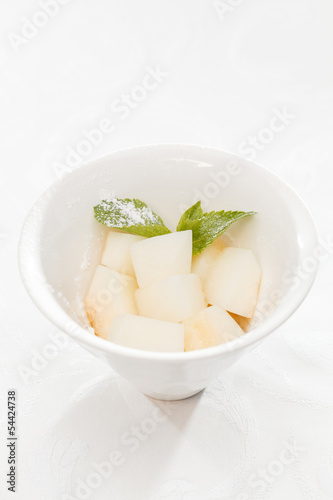Fresh melon cubes with mint leaves