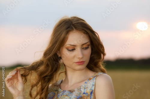 Beautiful woman in the wheat field