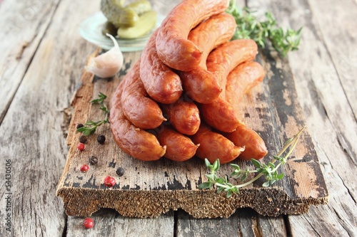 Smoked sausage on the natural background photo