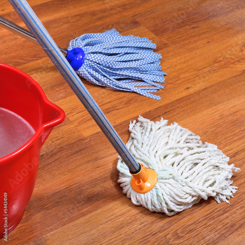 mopping of wood floors by two mops