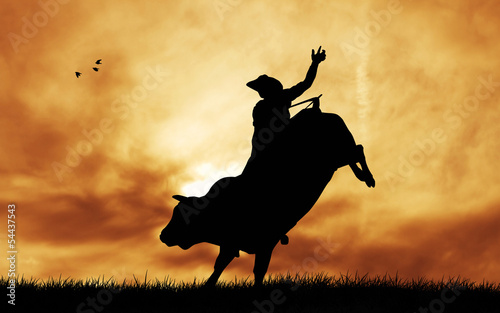Bull rider at sunset