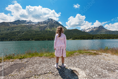 portrait of girl on the shore of a mountain lake