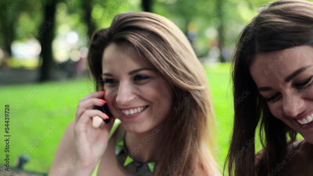 Young women with smartphone and cellphone in the park Young women with smartphone and cellphone in the park