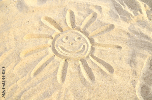smiling sun drawn in the sand