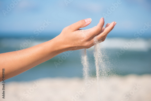 Sand falling from the woman's hand