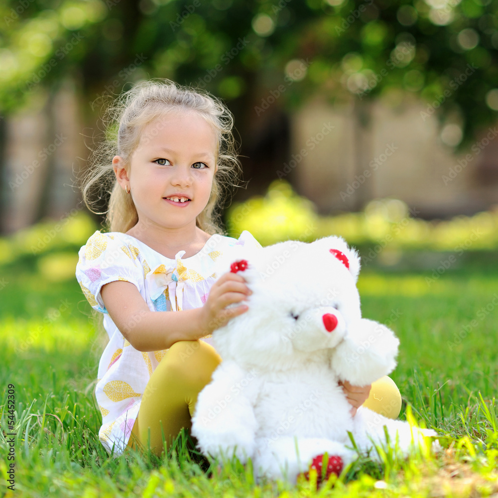 Sweet little girl outdoors with a toy bear Sweet little girl outdoors with a toy bear