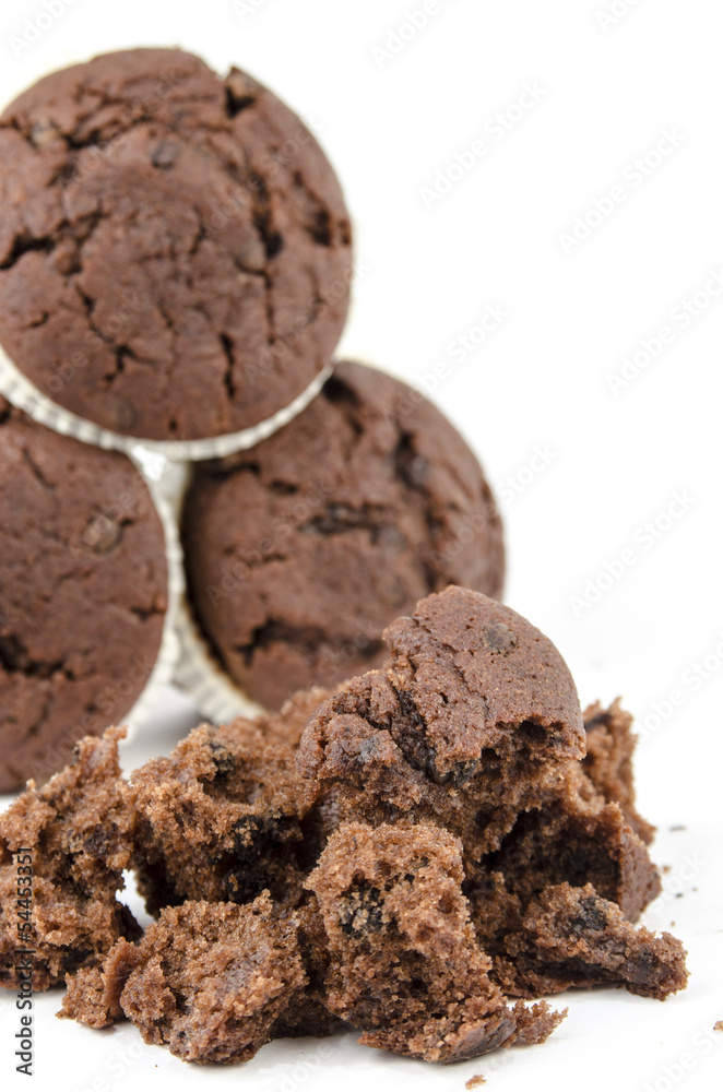 Group of chocolate muffins and crumbs- Isolated on white Group of chocolate muffins and crumbs- Isolated on white