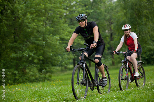 Man and woman riding bicycles