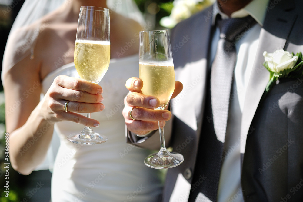 Bride and groom making a toast with champagne