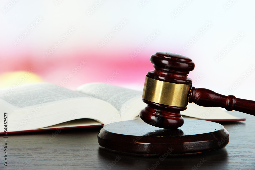 Gavel and book on table on light background Gavel and book on table on light background
