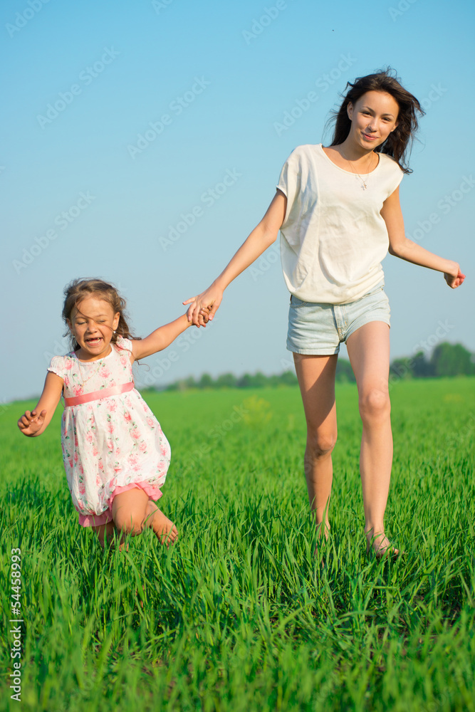 Young happy girls running at green wheat field Young happy girls running at green wheat field