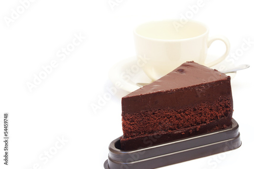 sliced chocolate cake with coffee cup on white background