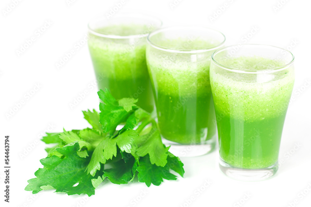 celery and three glasses with celery juice isolated on white celery and three glasses with celery juice isolated on white