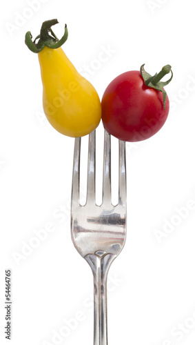 yellow and red tomatoes on the fork, diet concept © Vesna Cvorovic