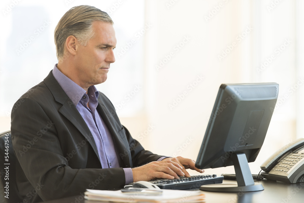 Businessman Using Desktop PC In Office Businessman Using Desktop PC In Office