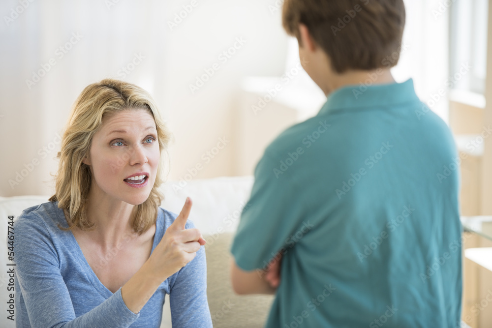 Fototapeta premium Angry Mother Scolding Son At Home