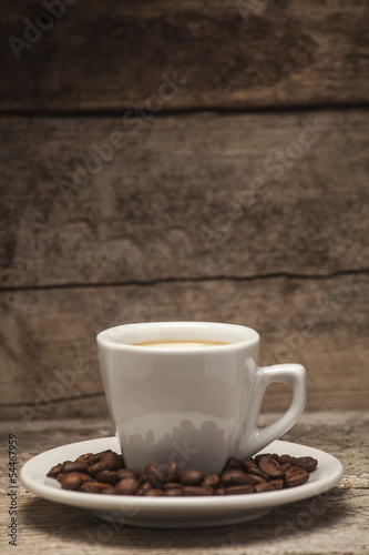 Coffee cup over a wooden background