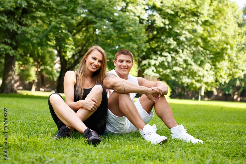 Young happy smiling sporty couple a park
