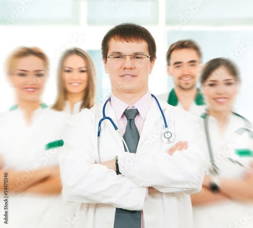 A team of young medical workers posing in white clothes