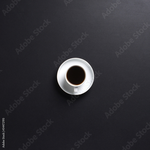 A cup of fresh coffee on a dark grey table background