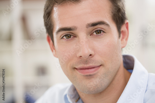 Interior portrait of looking relaxed happy male