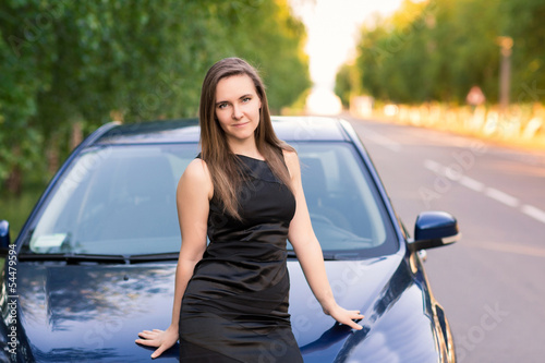 Beautiful businesswoman near her car
