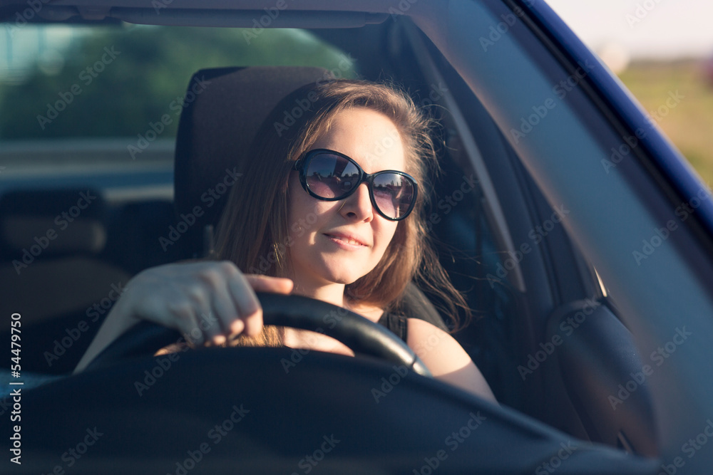 Beautiful businesswoman driving the car