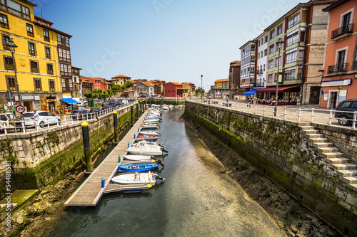 Boats moored in the harbor at low tide in Llanes, Asturias,Spain photo