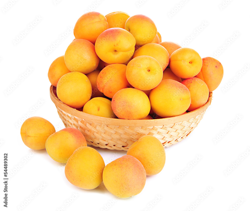 Fresh natural apricot in wicker basket isolated on white Fresh natural apricot in wicker basket isolated on white