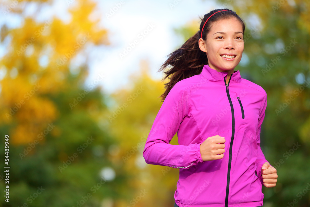 Running woman jogging in autumn forest in fall Running woman jogging in autumn forest in fall