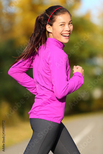 Fototapeta Naklejka Na Ścianę i Meble -  Asian woman running - female runner in autumn