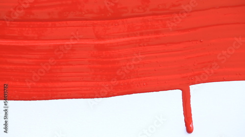 Hand with brush painting red background