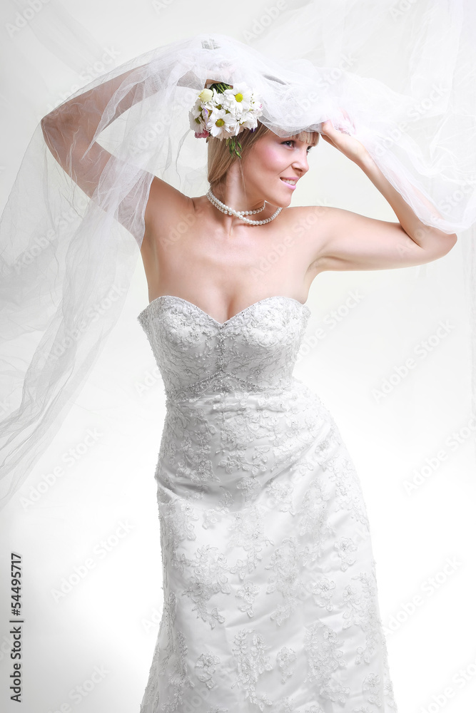 beautiful young woman in a white dress with a bouquet of flowers beautiful young woman in a white dress with a bouquet of flowers