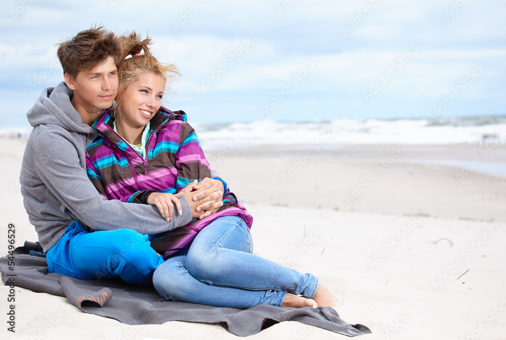 happy pair of male and female embracing and having fun wearing w