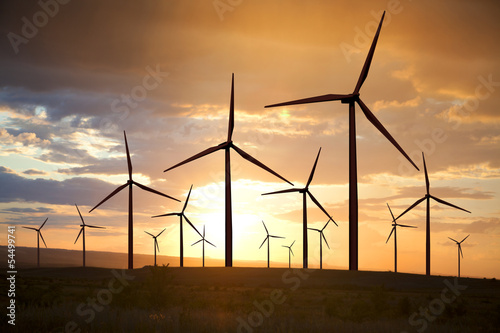 wind turbines on sunset sky photo