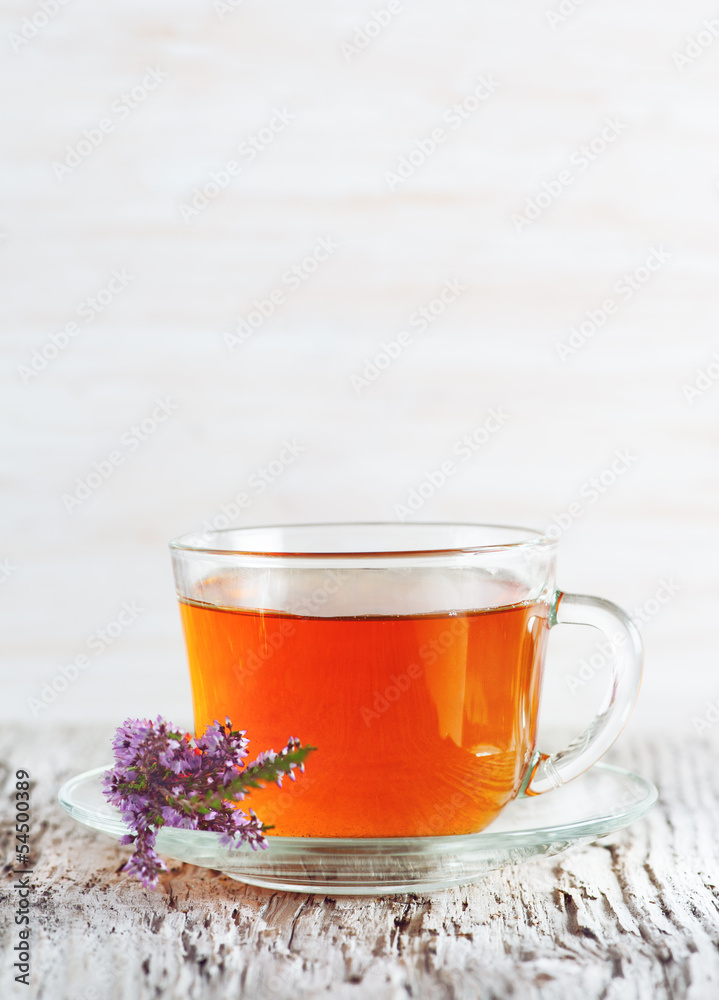 Fototapeta premium Cup of tea and branch of heather