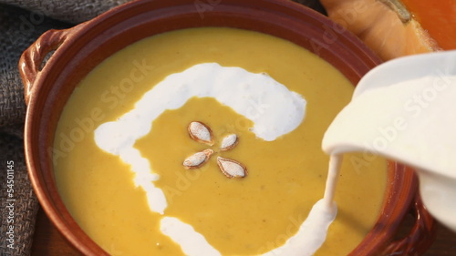 Pumpkin soup and pouring cream