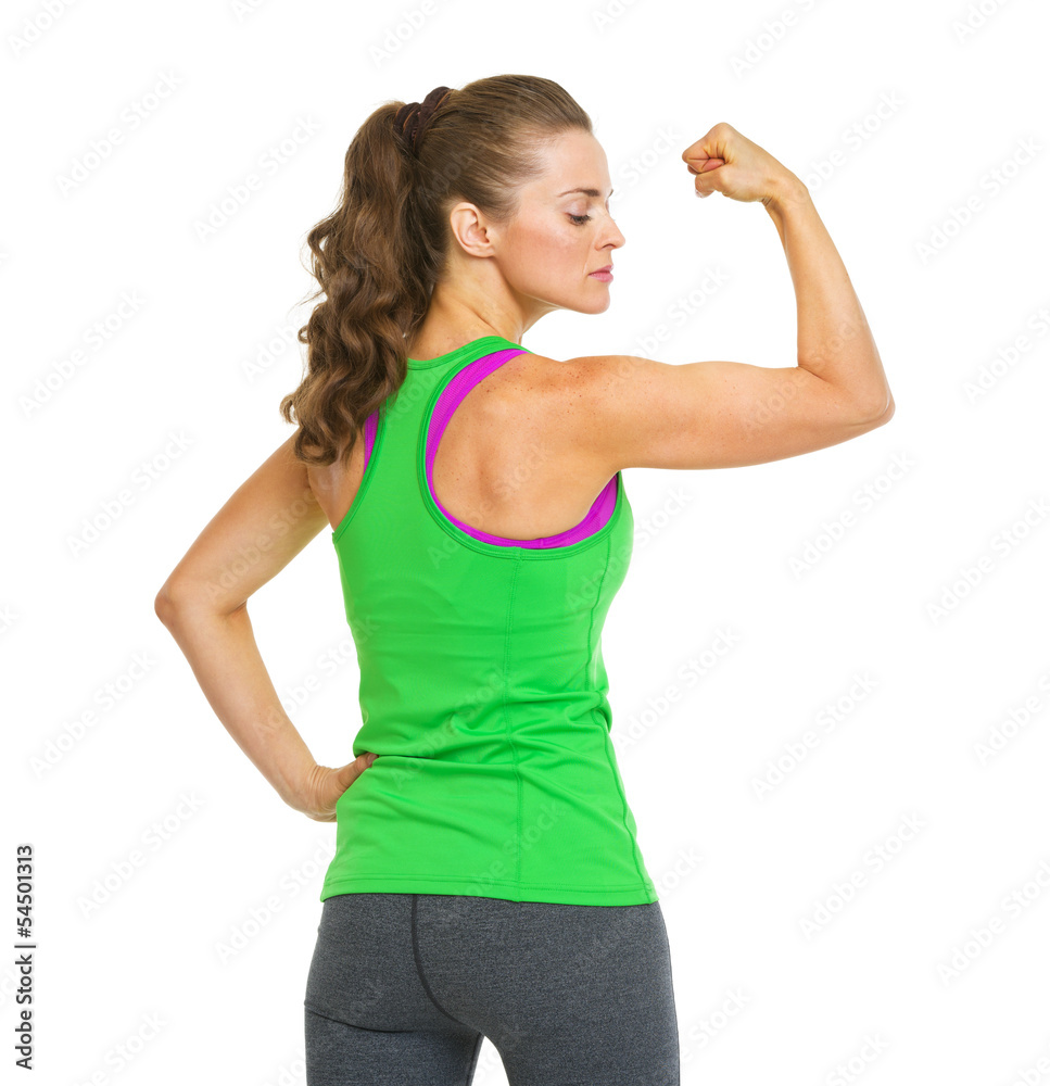 Portrait of female athlete showing biceps