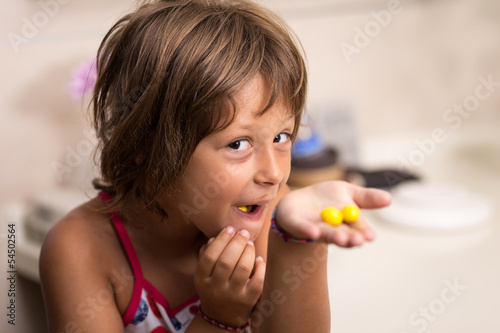Girl eating yellow candy