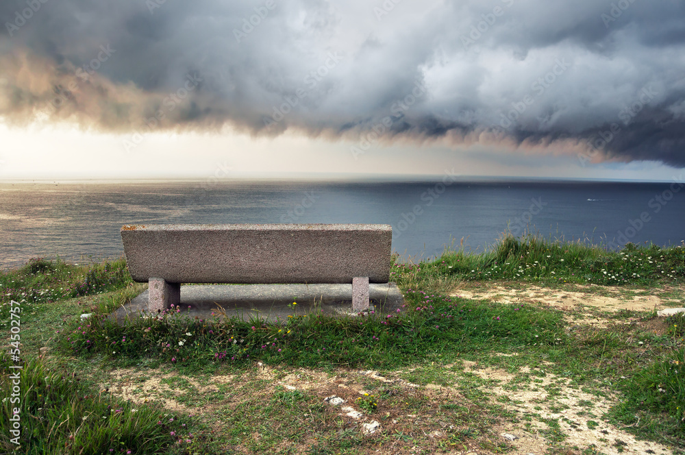 seat near sea with storm coming
