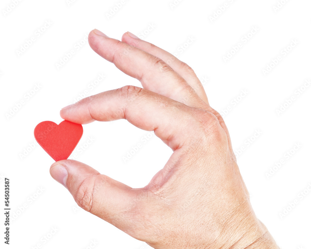 Man's hand holding a human heart. Symbol of health and love.