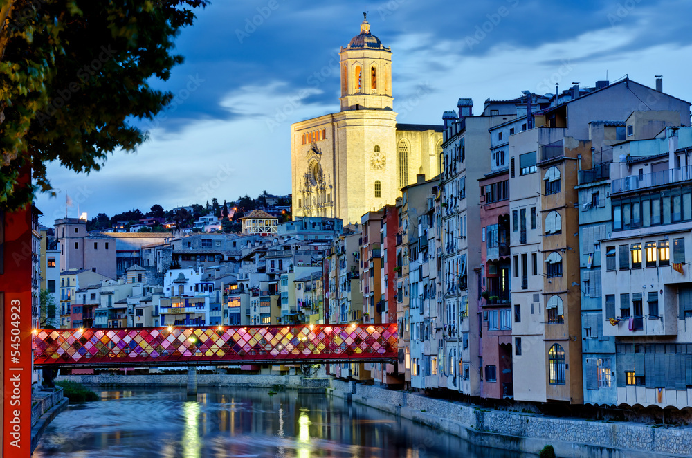 Girona by night with cathedral and decorated bridge