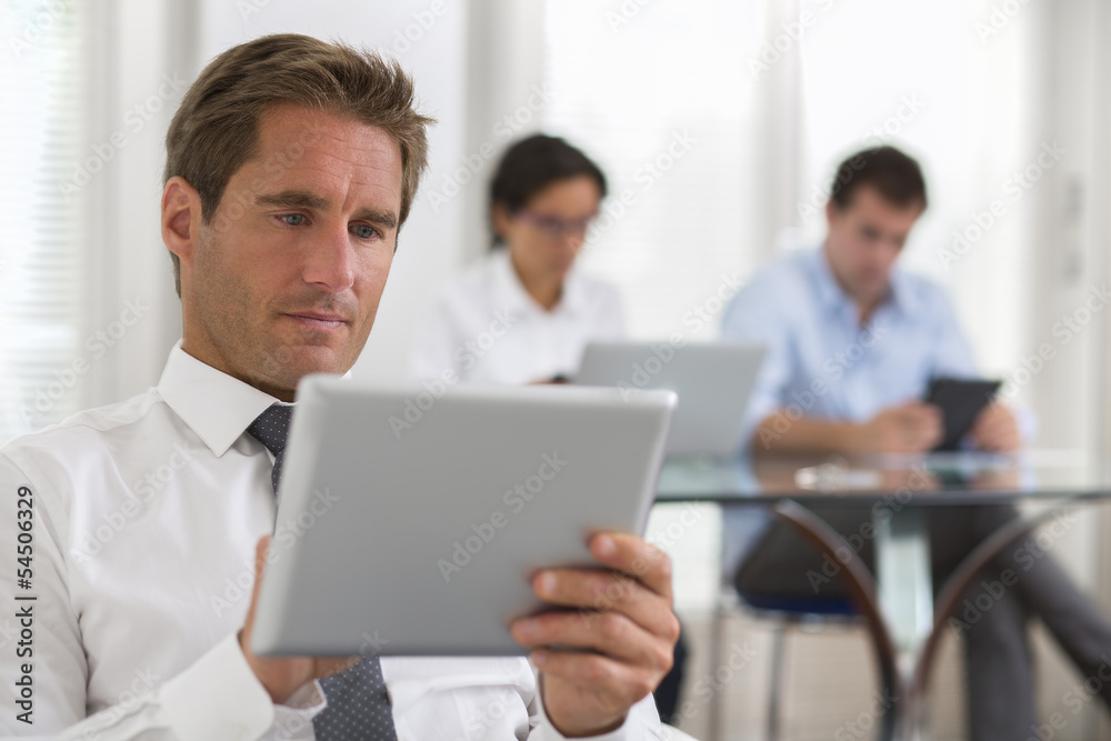 Businessman using his tablet in the office Businessman using his tablet in the office